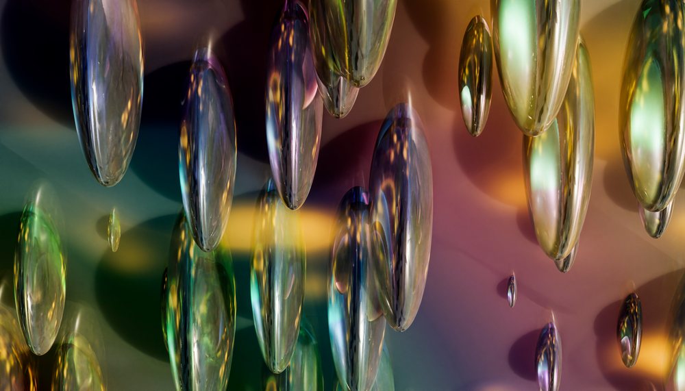 Glass droplets hanging as an abstract decorative installation with colorful reflections and ambient lighting.