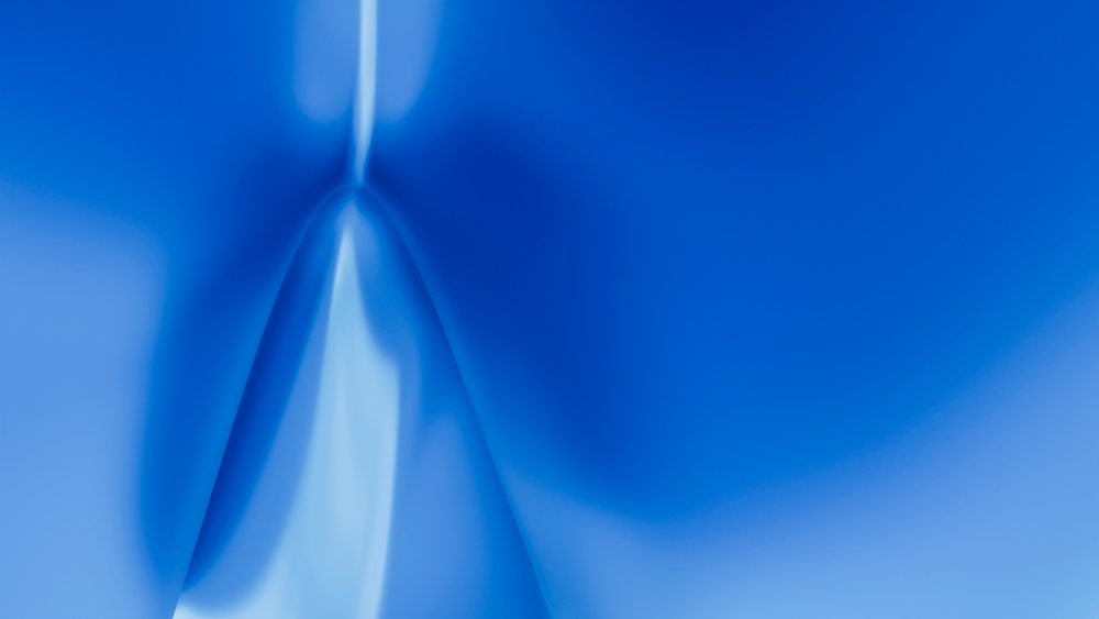 Blue abstract smooth surface with folds creating a silky texture and gradient tones.