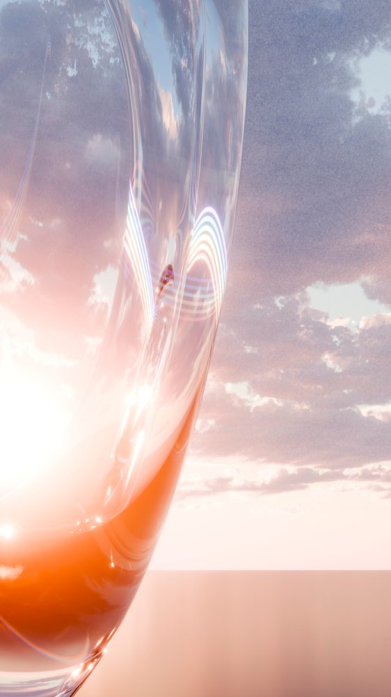 Abstract curved glass sculpture with translucent material reflects a glowing sunset sky and soft clouds, creating a smooth and shiny surface effect.