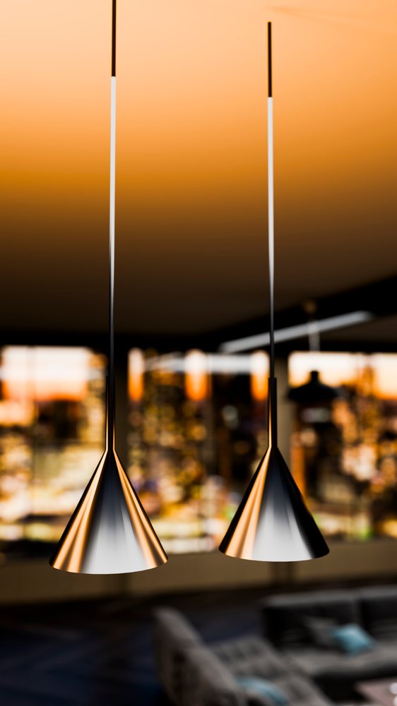 Modern cone-shaped metallic pendant lights hang in a contemporary living room at dusk.