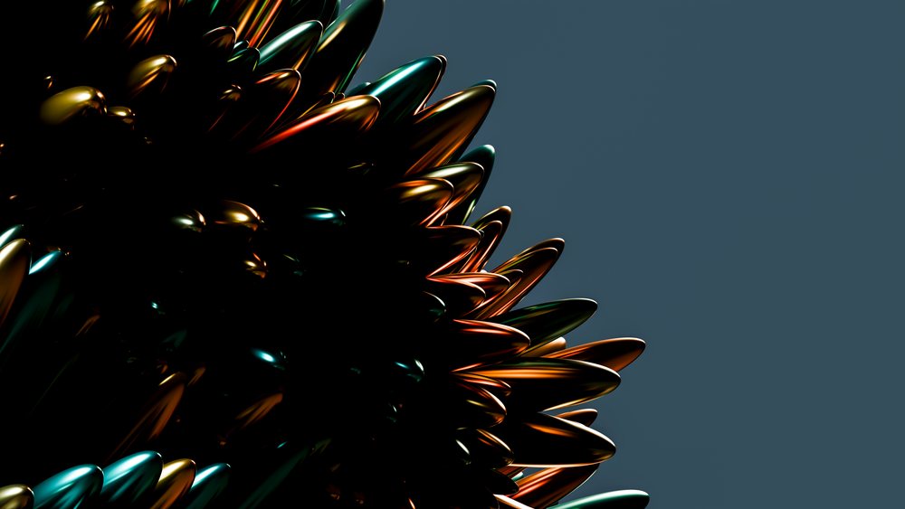Abstract metallic sculpture with spiked design reflecting orange and teal highlights against a dark studio background.