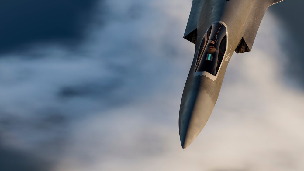 Fighter jet aircraft flying above clouds with visible pilot inside cockpit in aerial view, defense, war, security, military.