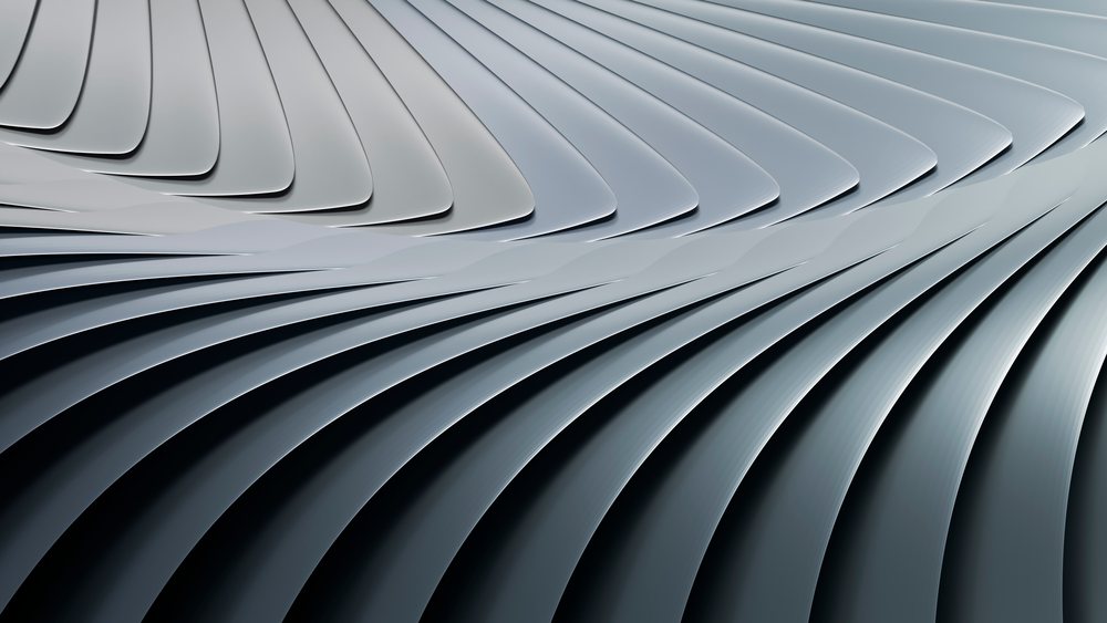 Curved overlapping grey metal shapes form a dynamic abstract pattern with smooth texture and subtle light shadows.