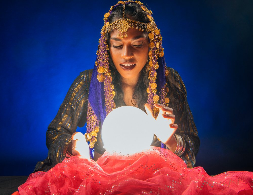A fortune teller gazes into a glowing crystal ball during a spiritual session in the, USA.
