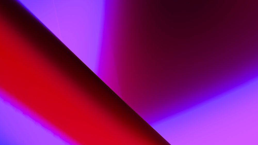 Abstract background featuring vibrant red and purple gradient lighting with smooth blended colors.