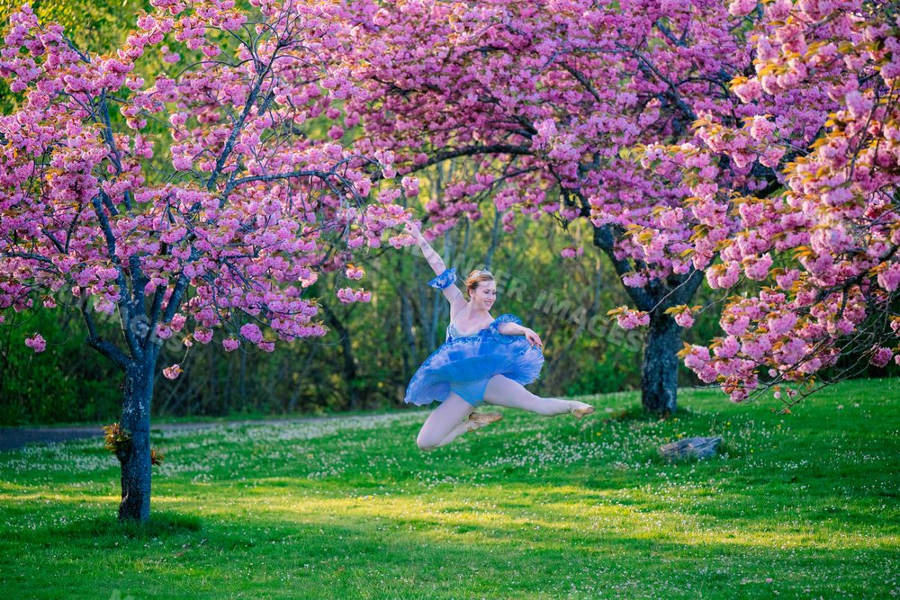 A white dancer jumps gracefully