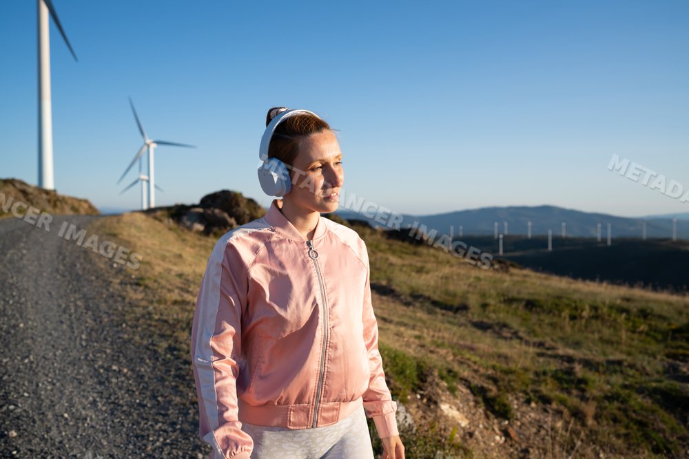 A white woman listens to music
