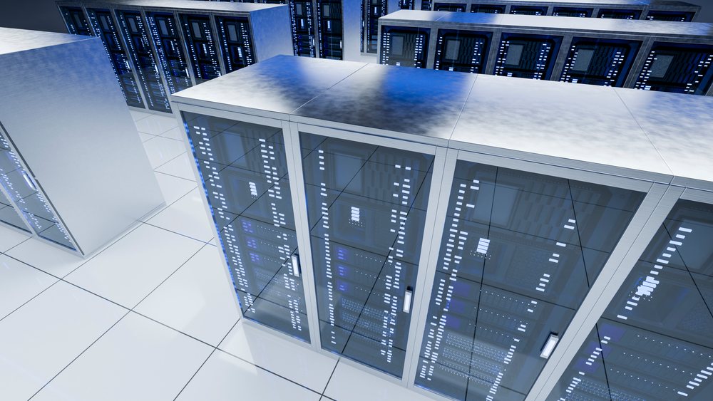Server racks with computer servers and network equipment in a clean, modern data center environment with reflective flooring and blue indicator lights.