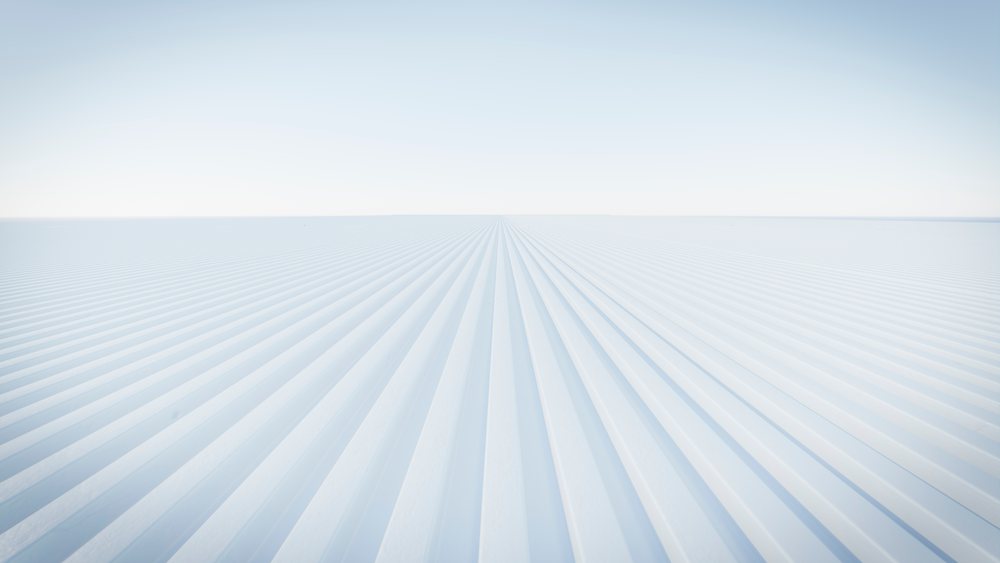 Industrial corrugated metal roof panels extend toward the horizon under a clear blue sky in an outdoor scene, car, manufacturing, industry.