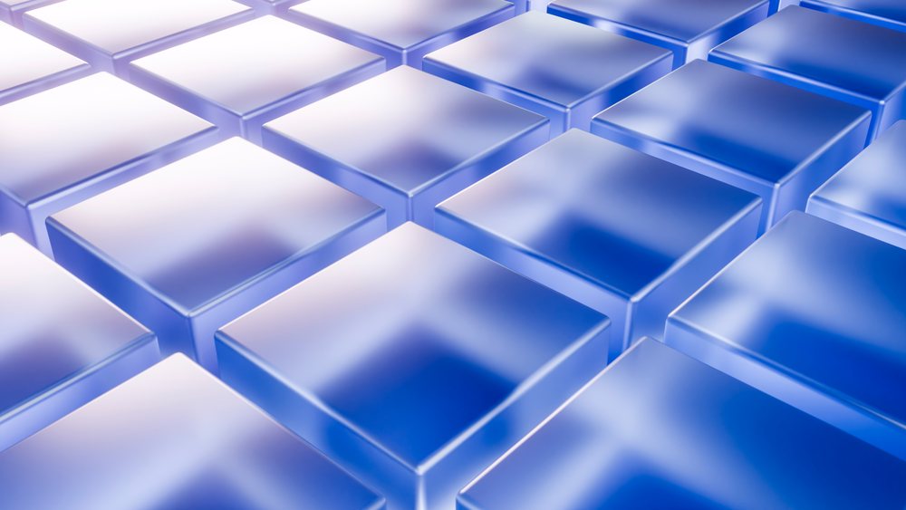 Pattern formed by transparent blue and white 3D glass blocks arranged in a geometric grid layout.