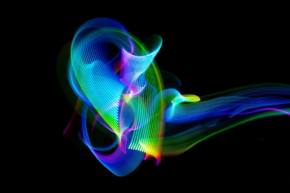 Colorful LED light painting creating abstract swirling patterns on a black background, Germany.