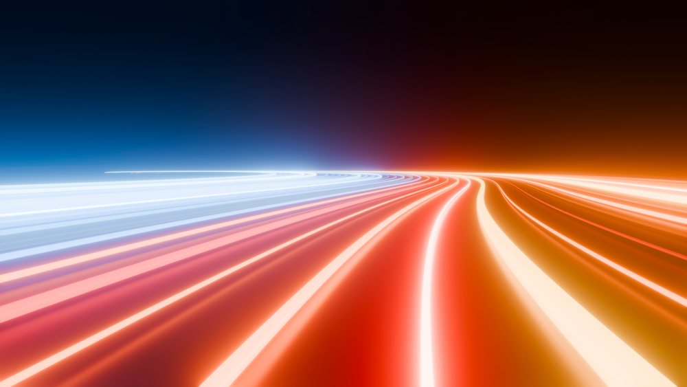 Curved light trails in blue and red form an abstract, dynamic pattern on a dark background.