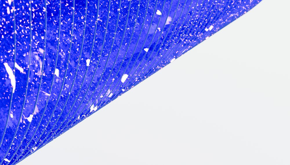 Blue solar panel with rows of photovoltaic cells capturing sunlight for renewable energy production.