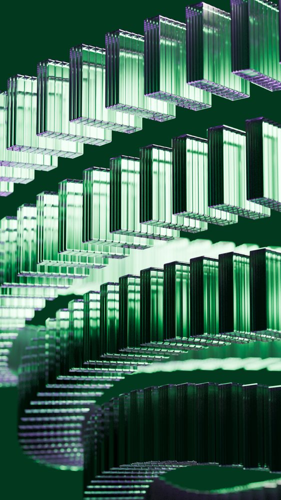 Stacked transparent green glass rectangular prisms arranged in a vertical repeating pattern on a dark background.