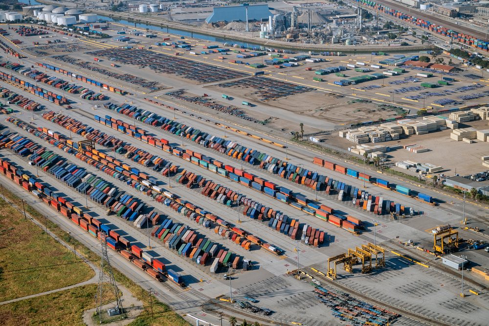 Container yard with freight containers and cargo handling equipment at the Port of Long Beach, lifornia, CA, USA.