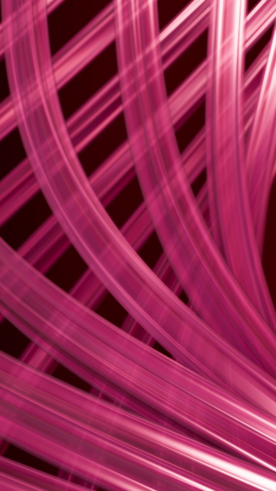 Close-up of glossy pink ribbons overlapping on a dark red background forming a decorative abstract pattern.