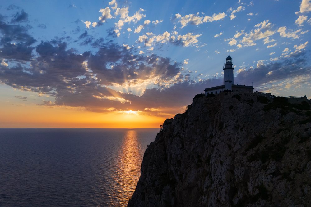 Far de Formentor Lighthouse stands atop a rocky cliff at sunrise over the sea, Landscape, Lifestyle, Polença, Mallorca, Spain.
