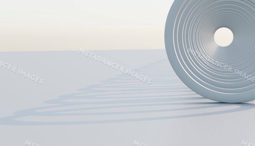 Close-up of a steel coil compression spring casting a spiral shadow