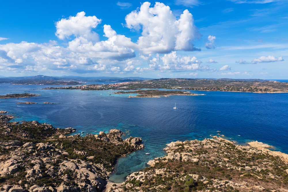 Aerial view of Cala Caprarese showing rocky coastline and blue Mediterranean waters, Travel Images, La Maddalena, Sardinia, Italy.