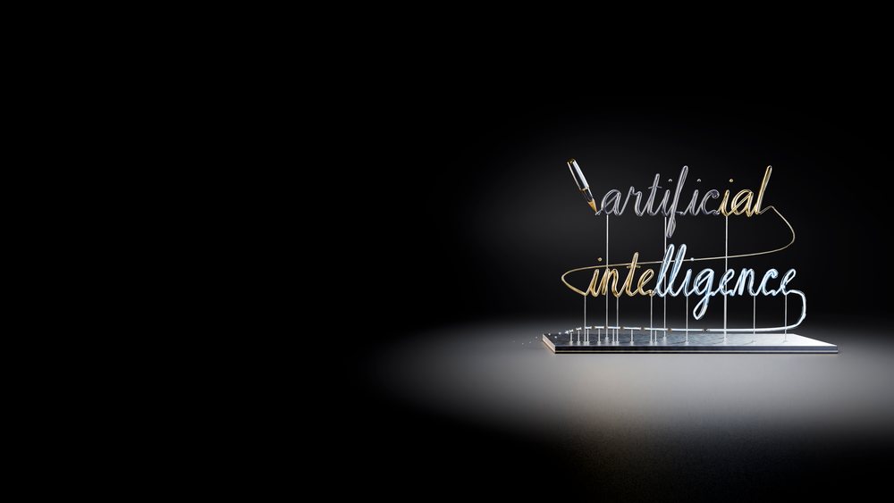 Neon sign spelling artificial intelligence with a pen writing on a dark background under spotlight.