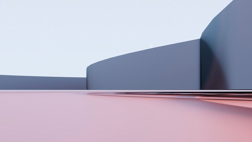 Curved modern blue architectural building exterior with smooth pink ground beneath under clear sky in an urban environment.