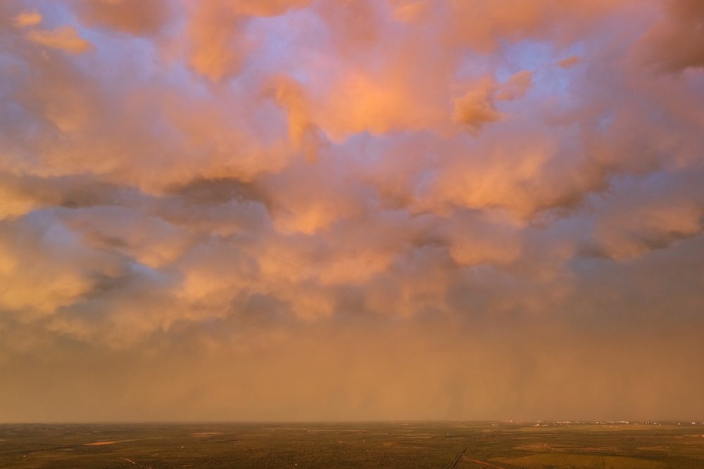 Clouds glowing at Sunset on the backside of a Supercell storm over the open plains, Storm Chasing, Weather, Environment, Uvalde, Texas, USA.