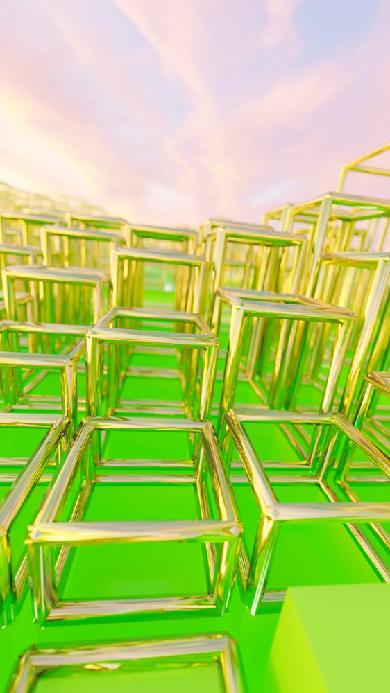 Golden metal cubes with open frames arranged on a green surface under a pink and purple sunset sky in an abstract geometric composition.