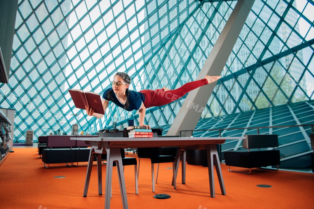 A woman reading a book balancing