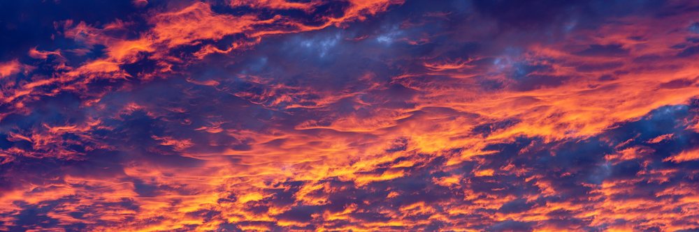 Sky filled with dramatic orange and purple clouds during a vibrant sunset.