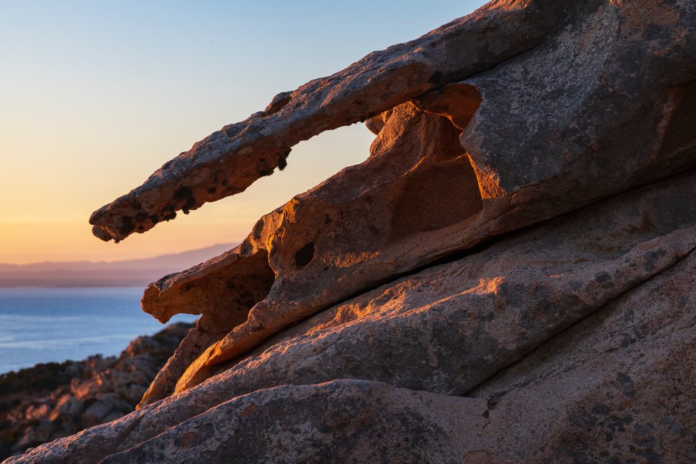 Sunset illuminates the eroded Granite rock formation along the coastal landscape of, Travel Images, La Maddalena, Sardinia, Italy.