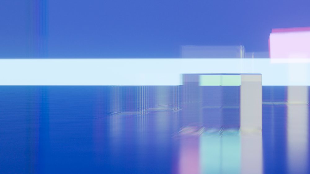 Abstract digital illustration with colorful shapes, reflections, and a glowing horizontal light line on a blue surface.