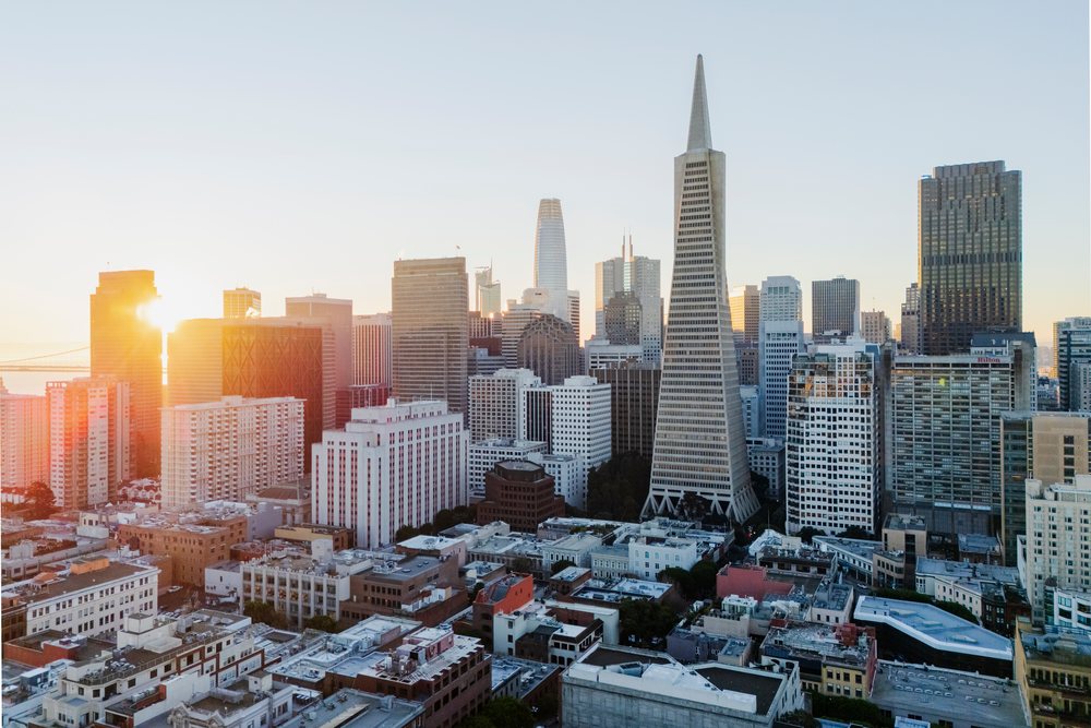 Sunrise over downtown San Francisco with the Transamerica Pyramid and Bay Bridge near Pier 7 visible in the urban skyline, landscape, cityscape, city life, California, USA.