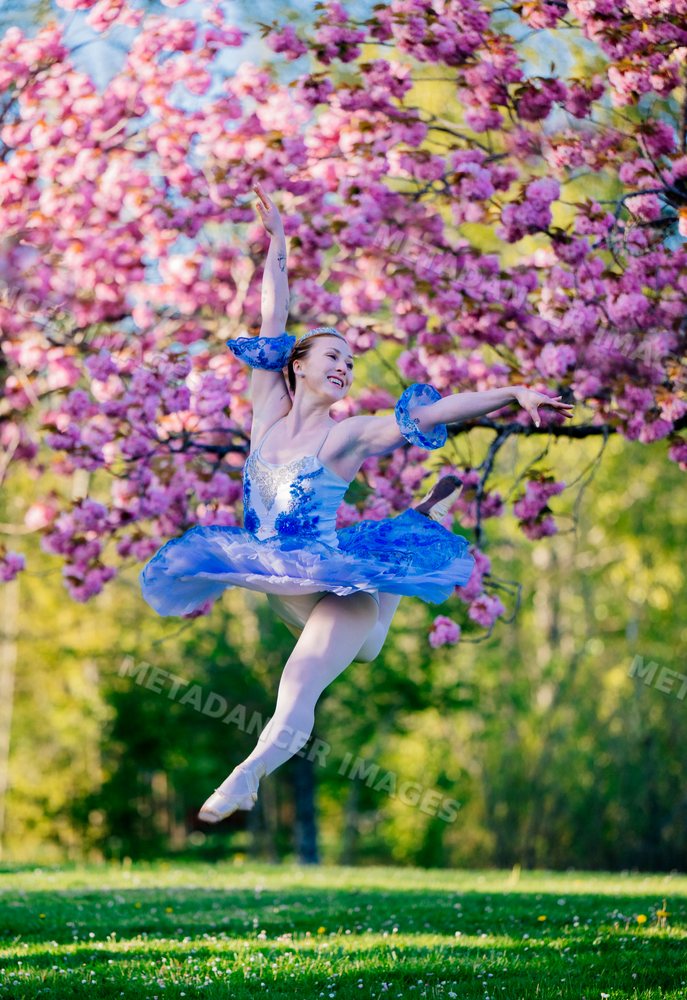 Ballerina leaps gracefully outdoors
