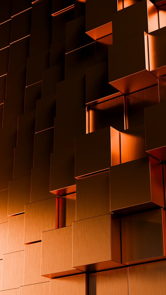 Close-up of a modern architectural wall with a pattern of copper-colored metal cubes.