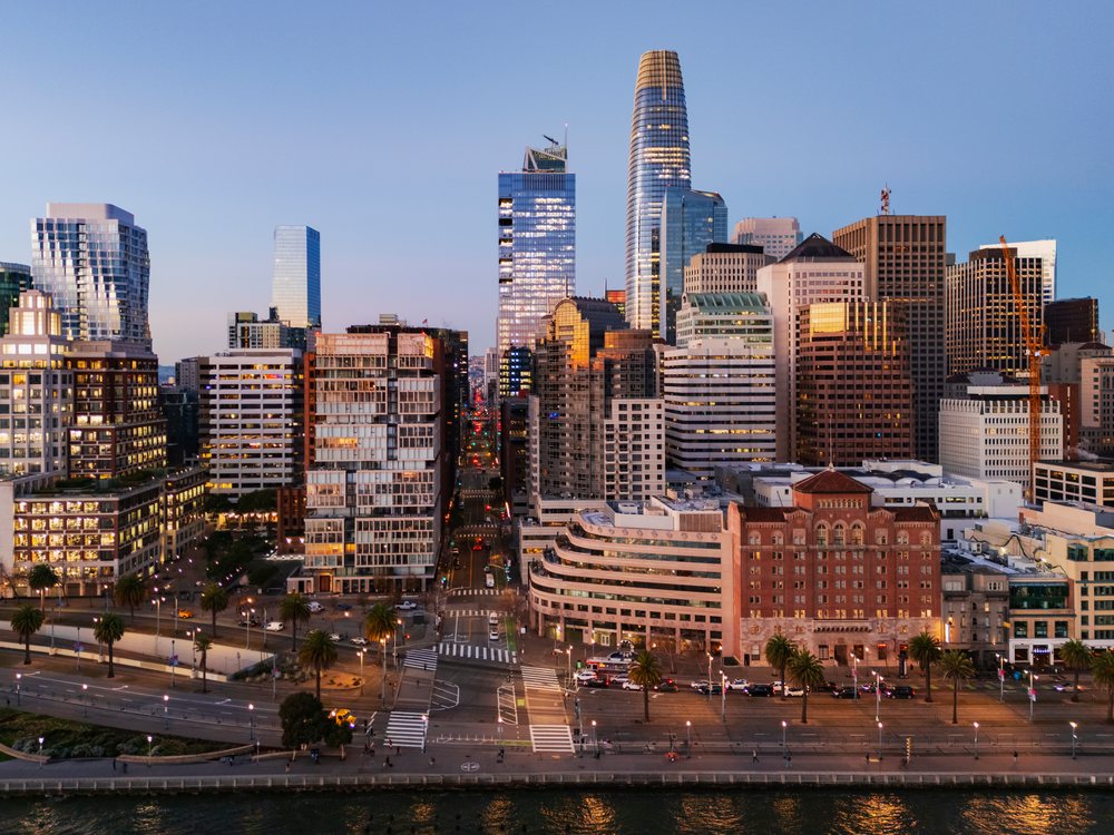 Downtown San Francisco viewed along Howard Street from the waterfront near Pier 7 at twilight with illuminated office buildings and city skyline, landscape, cityscape, city life, California, USA.