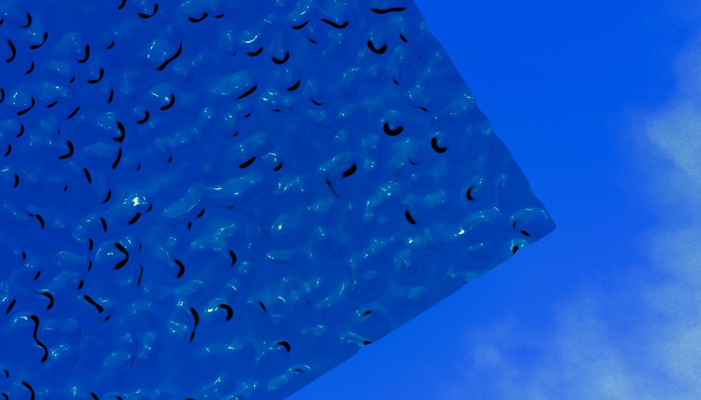 Blue textured surface with shiny black curved shapes creating an abstract decorative pattern.
