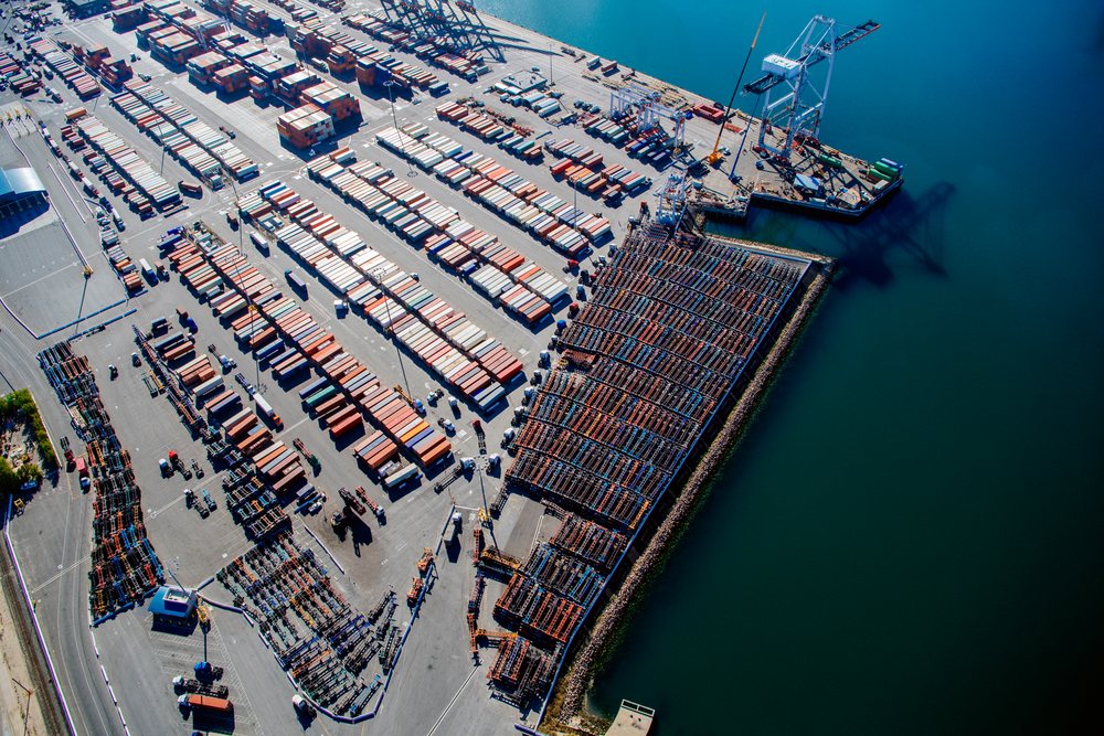 Aerial view of shipping container stacks and cranes at the container terminal in the port located in Long Beach, lifornia, USA.