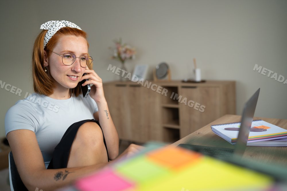 White Woman working from home talks on the phone