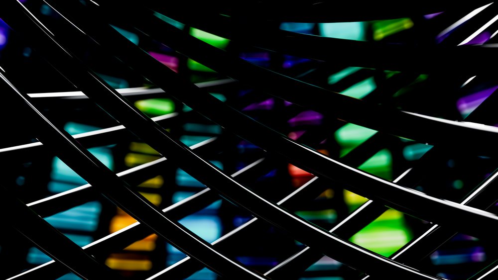 Black metal bars intersect in front of colorful stained glass with bright reflections and geometric shapes in an abstract modern design.