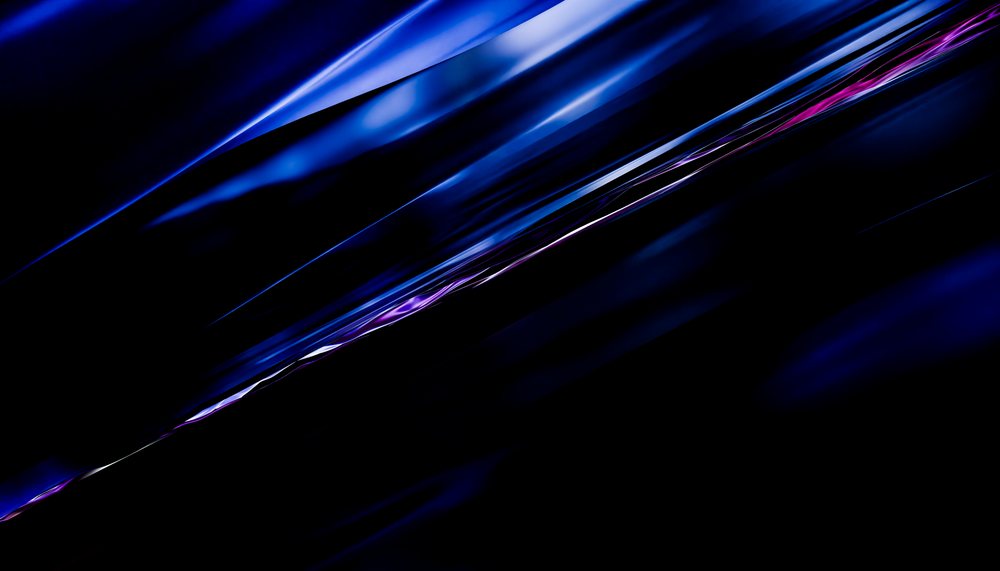 Abstract glossy dark blue and purple light streaks with reflective surfaces on a black background.