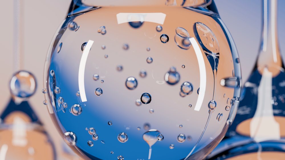 Close-up abstract illustration of transparent fluid spheres with floating bubbles and blue and orange reflections clustered together.