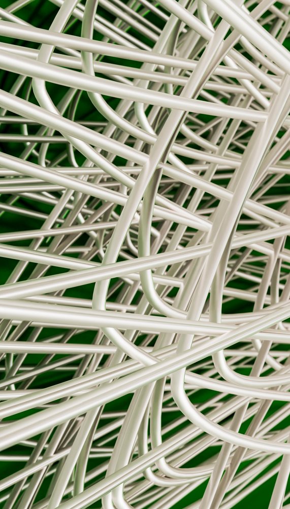 Close-up of entangled white cables forming a complex mesh against a green background in a technology composition.