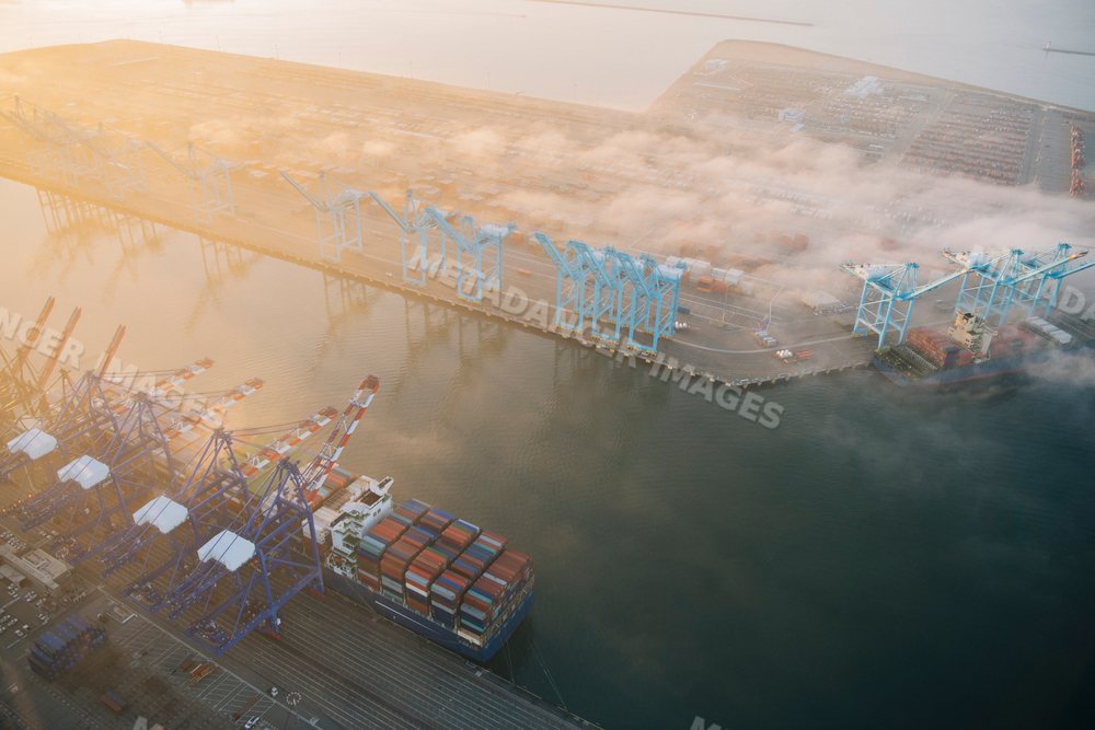 An aerial view of cargo port operations with container cranes in Long
