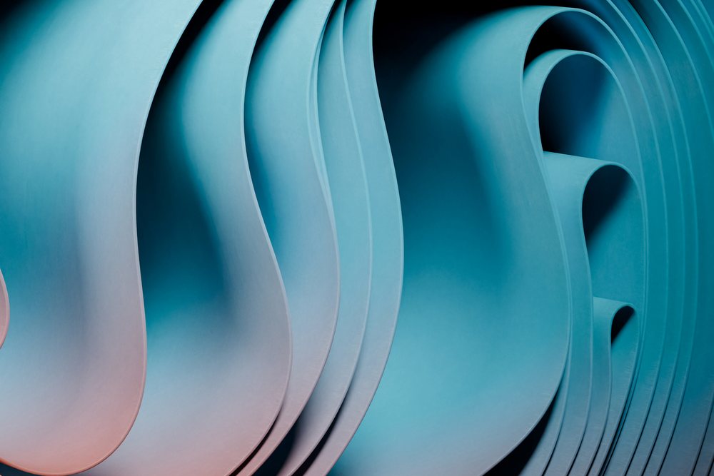 Abstract render of curved layered shapes with a blue gradient and smooth surfaces.