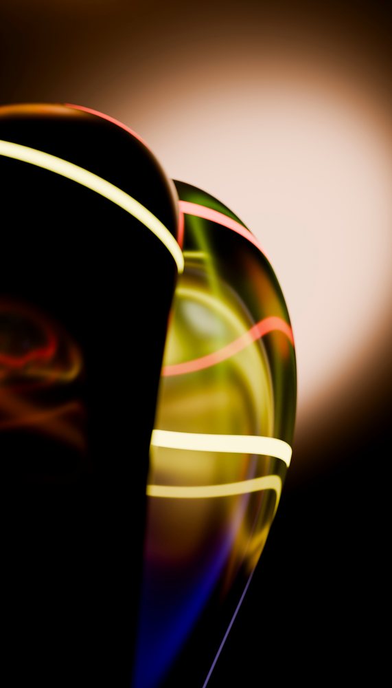 Abstract glass sculpture with glowing colorful light lines against a dark background in a studio setting.
