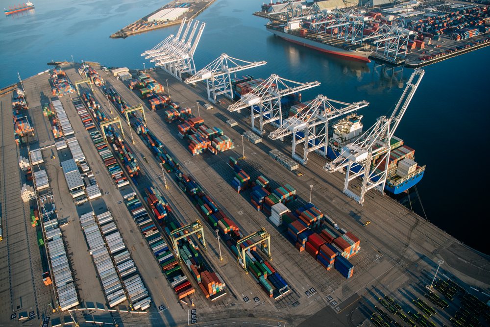 Shipping containers stacked and container cranes loading cargo ships at a major rgo terminal in Long Beach, a major cargo terminal in Long Beach, CA, USA.