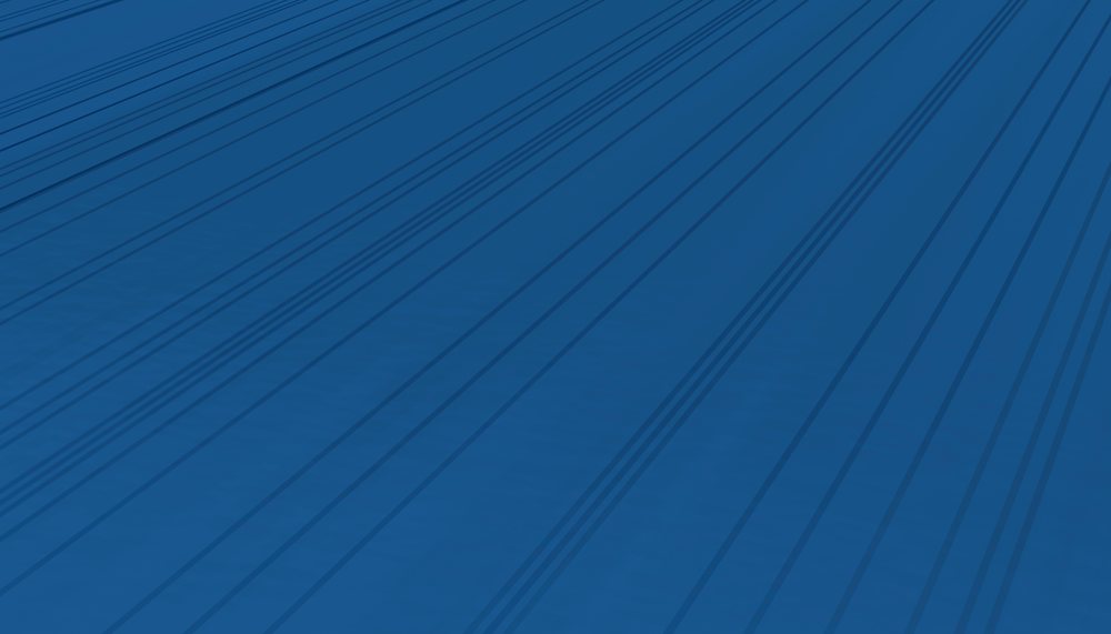Blue surface featuring dark parallel lines and shadows creating a geometric abstract pattern.