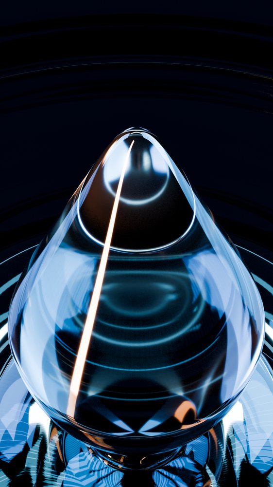 Transparent glass droplet with light reflections and blue highlights rests on a dark surface under studio lighting.