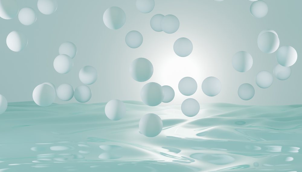 Abstract 3D render of floating blue spheres above a reflective liquid surface with soft lighting effects.