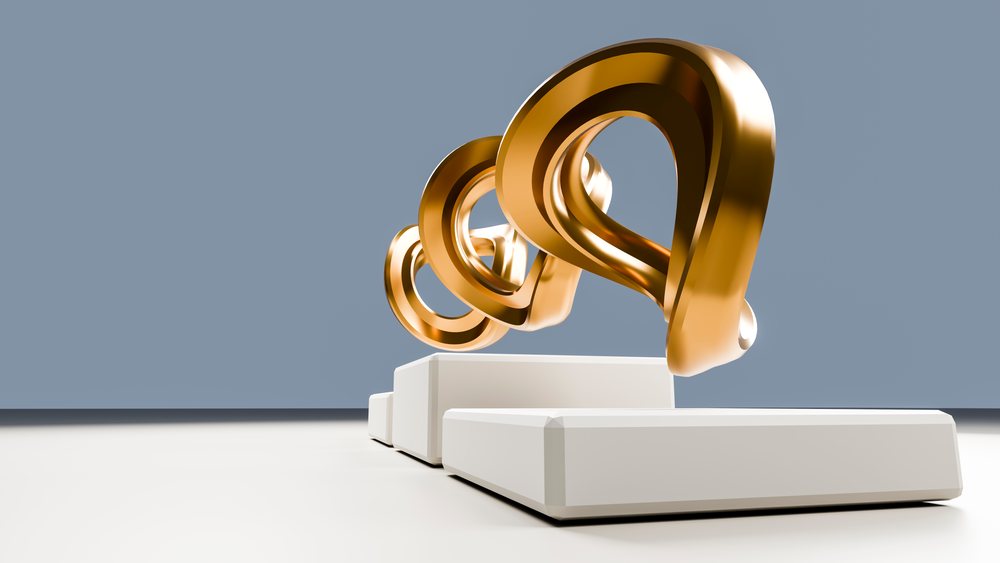 Three golden abstract loops floating on white rectangular platforms in a minimalist studio with a blue-gray background.